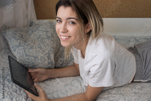 Very young girl with computer in bed photo