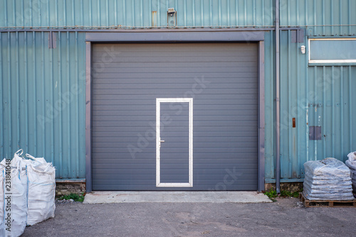 Industrial warehouse with dark grey door for vehicle