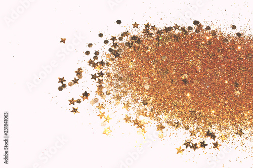 Golden glitter and glittering stars on white background © mila_1989