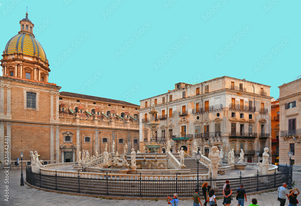 The Praetorian Fountain, Fontana Pretoria with the dome of Santa Caterina in the background is a monumental fountain that represents mythological figures and animals, Palermo, Sicily, Italy