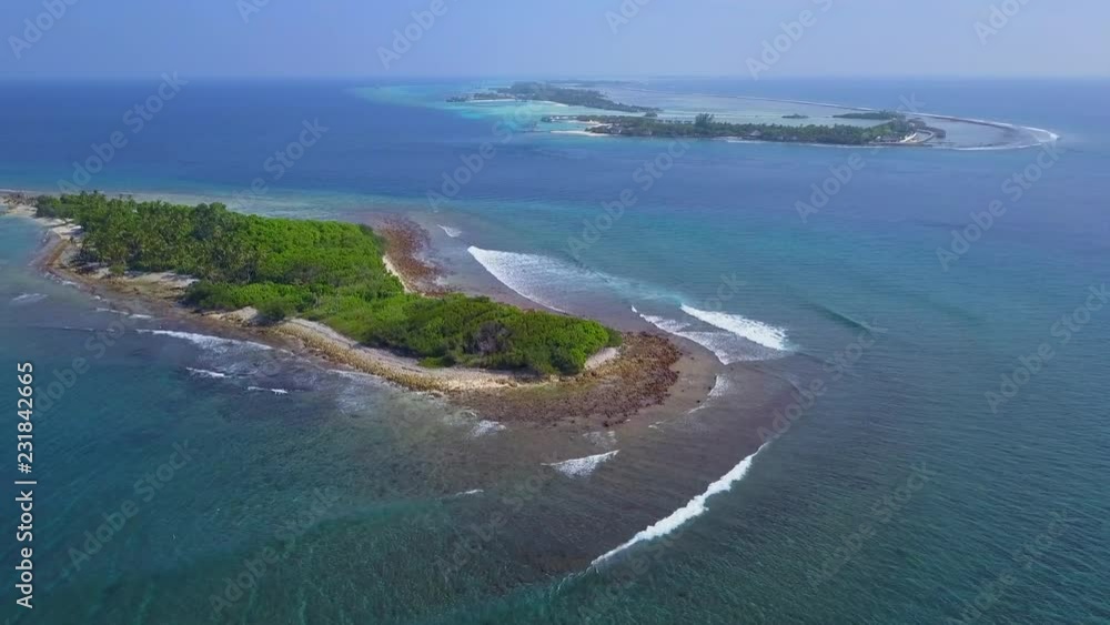 Flight over the tropical islands in the Indian Ocean. Island of Thanburudhoo with surf spots named Sultans and Honky's is located on the foreground. Maldives Flight over the tropical islands in the Indian Ocean. Island of Thanburudhoo with surf spots named Sultans and Honky's is located on the foreground. Maldives