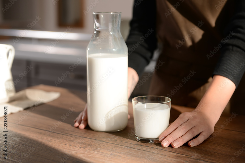 Woman drinking tasty milk at table Woman drinking tasty milk at table