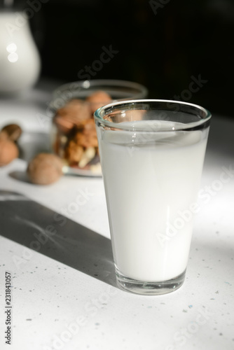 Full glass of fresh milk on light table