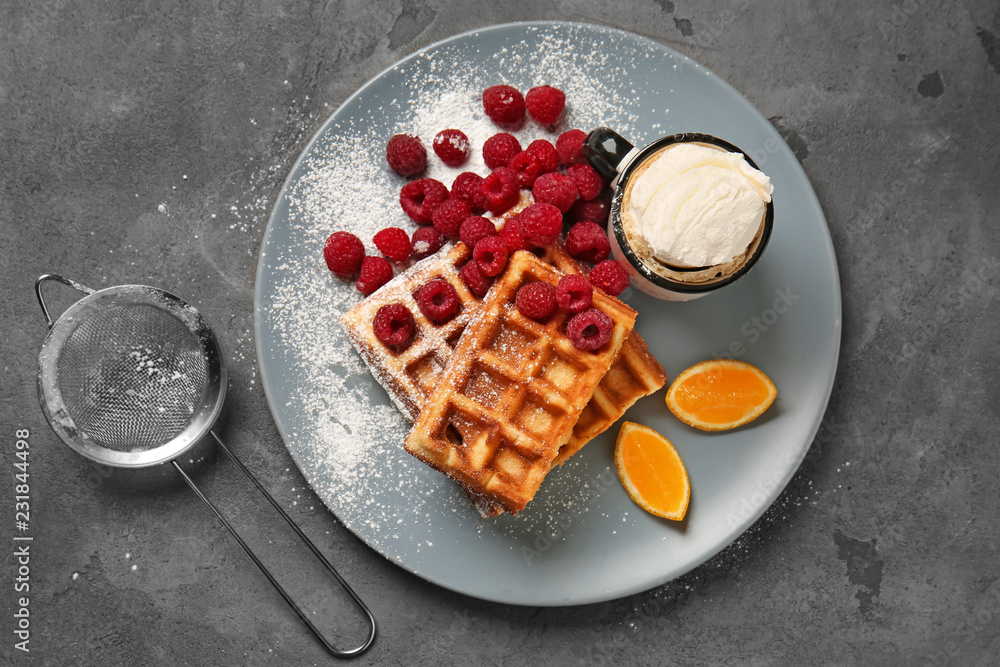 Tasty waffles with berries and ice cream on plate