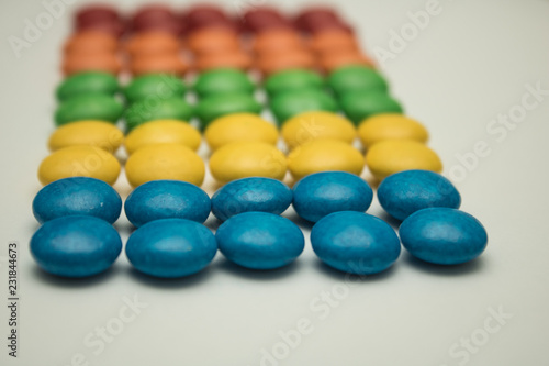 colorful beads in shape of heart on white background