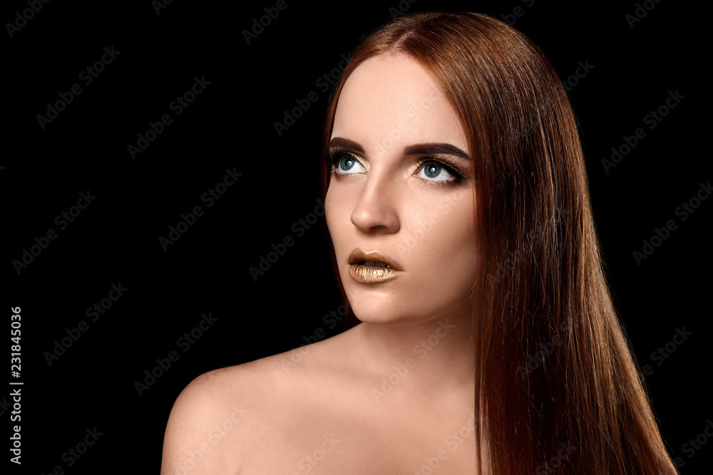 Obraz premium Beautiful woman with golden make up against dark background