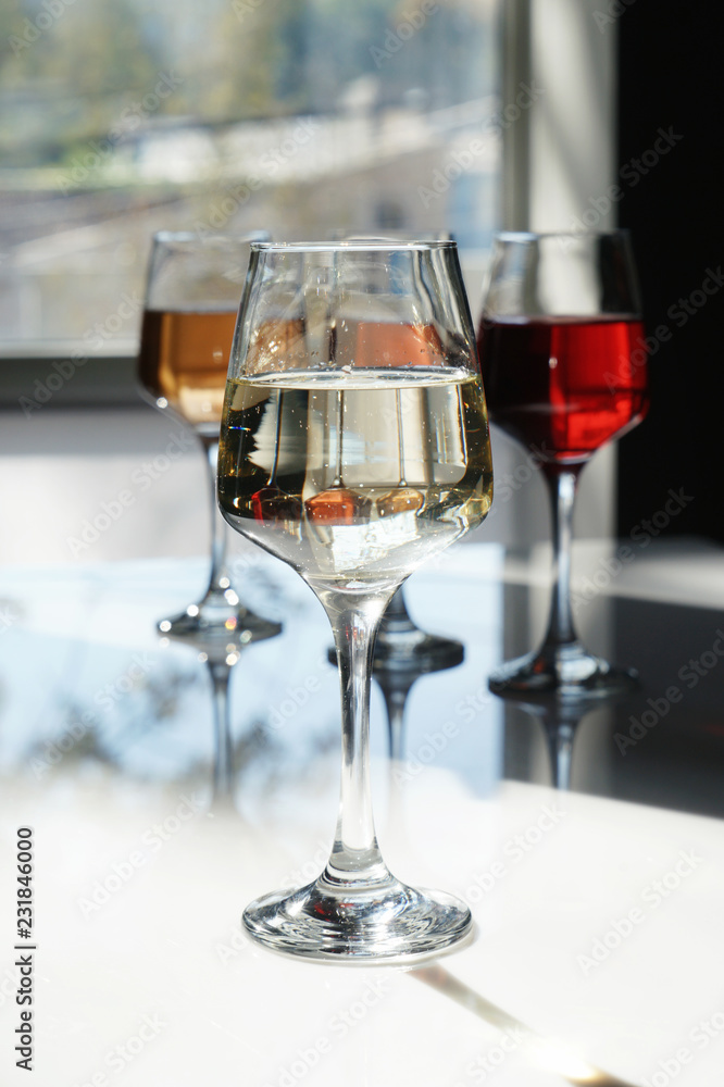 Glasses of tasty wine on table