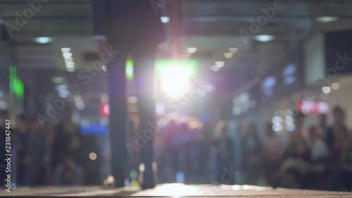 Wallpaper Mural stylish male model in solid costume and shoes walk the podium during a fashion show in backlight on background blurred audience Torontodigital.ca