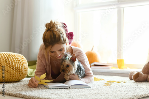 Woman with cute dog reading...