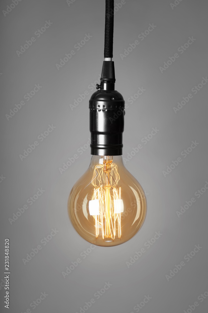 Retro light bulb on grey background Retro light bulb on grey background