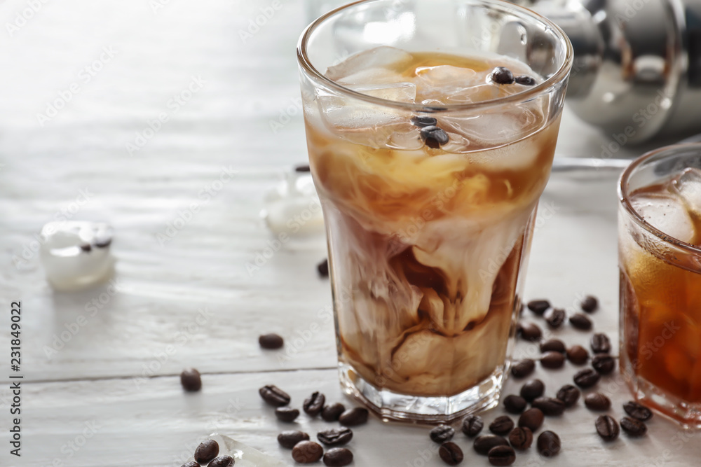 Glasses with cold coffee on white table Glasses with cold coffee on white table
