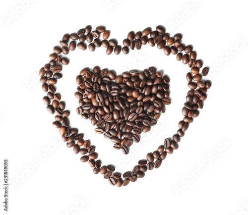 Heart made of roasted coffee beans on white background