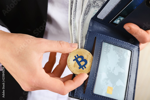 Woman taking bitcoin out of...