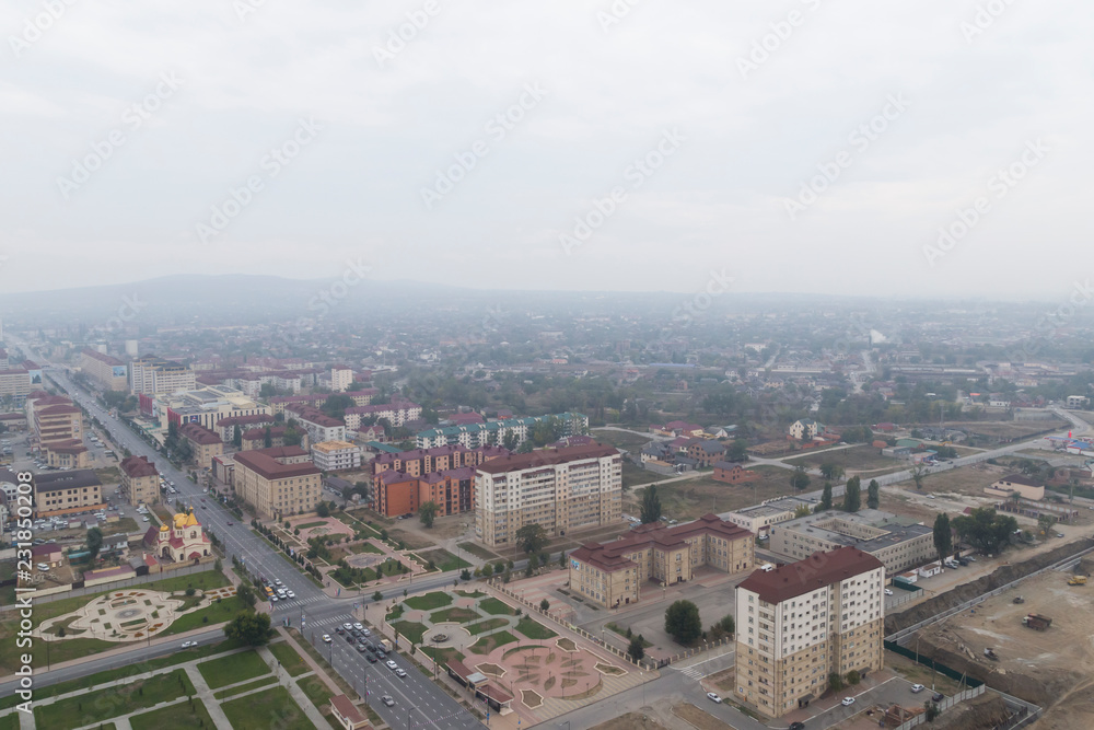 Grozny, Russia: 10.07.2015. Daily life in Chechen Republic. Aerieal view on new houses on Akhmat Kadyrov Avenue, Flower Garden park and the Orthodox Church of St. Michael the Archangel