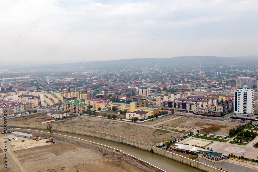 Grozny, Russia: 10.07.2015. Daily life in Chechen Republic. Aerieal view on river Sunzha and new houses.