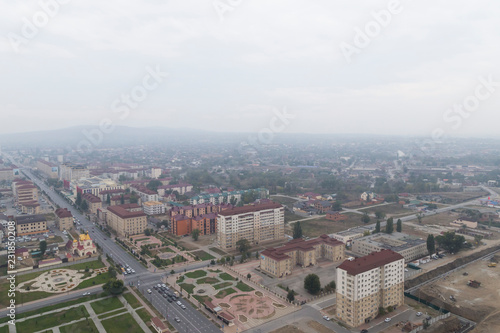 Grozny, Russia: 10.07.2015. Daily life in Chechen Republic. Aerieal view on new houses on Akhmat Kadyrov Avenue, Flower Garden park and the Orthodox Church of St. Michael the Archangel © Olga Shuklina