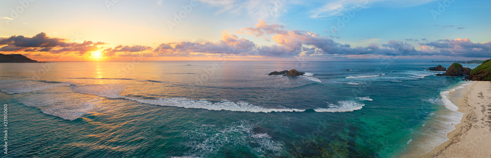 Panoramic view of tropical beach with surfers at sunset. - obrazy, fototapety, plakaty 