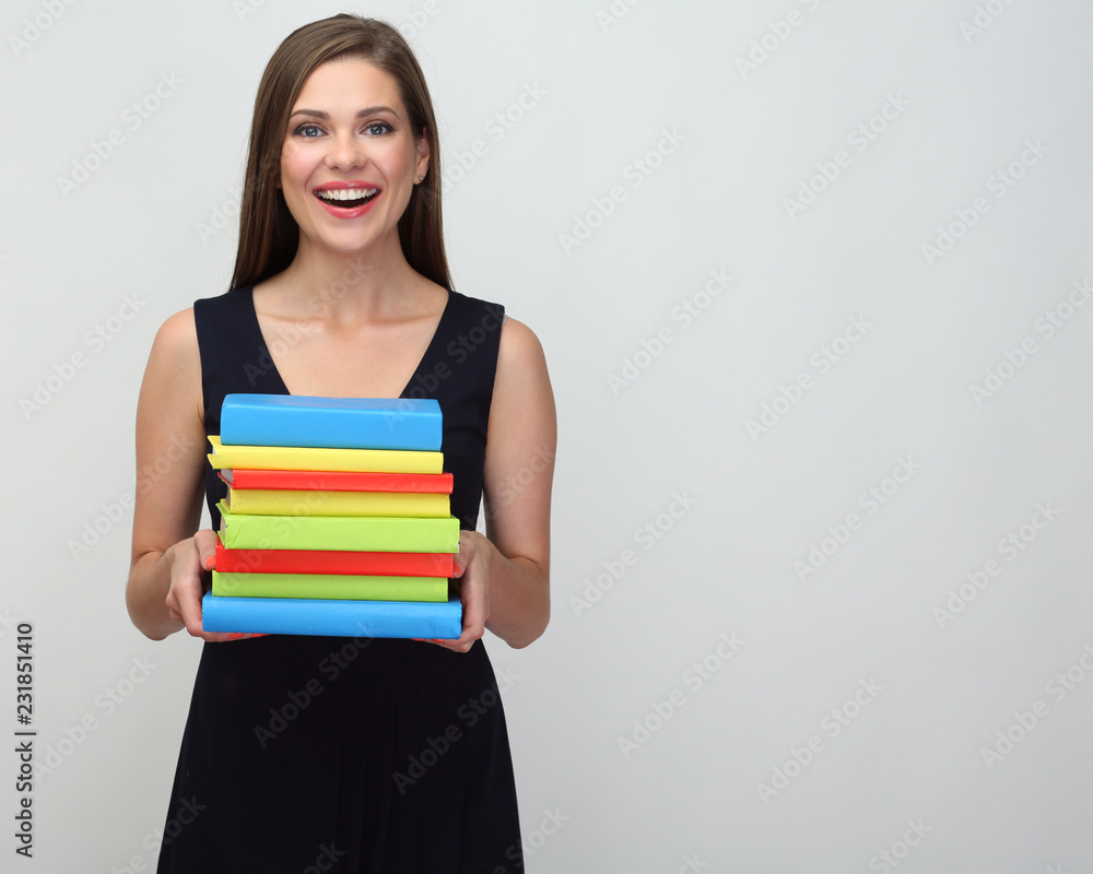 Happy student girl holding pile of books. Happy student girl holding pile of books.