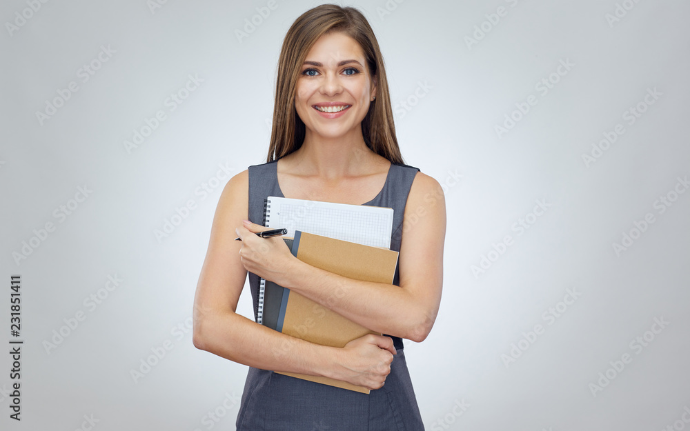 Smiling positive teacher standing against isolated back Smiling positive teacher standing against isolated back