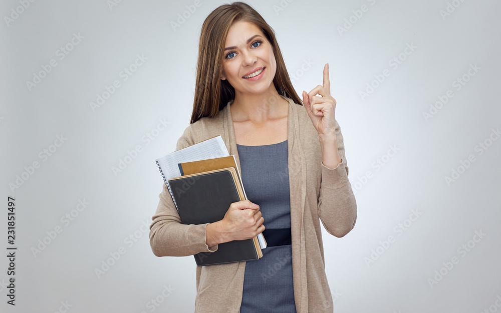 Smiling woman teacher pointing up with finger. Smiling woman teacher pointing up with finger.