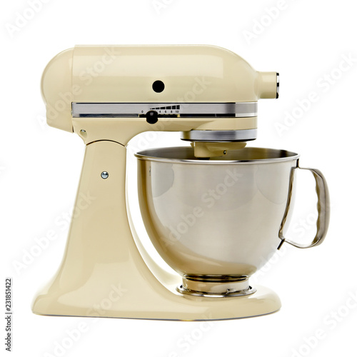 Beige or yellow stand mixer from side on white background including clipping path