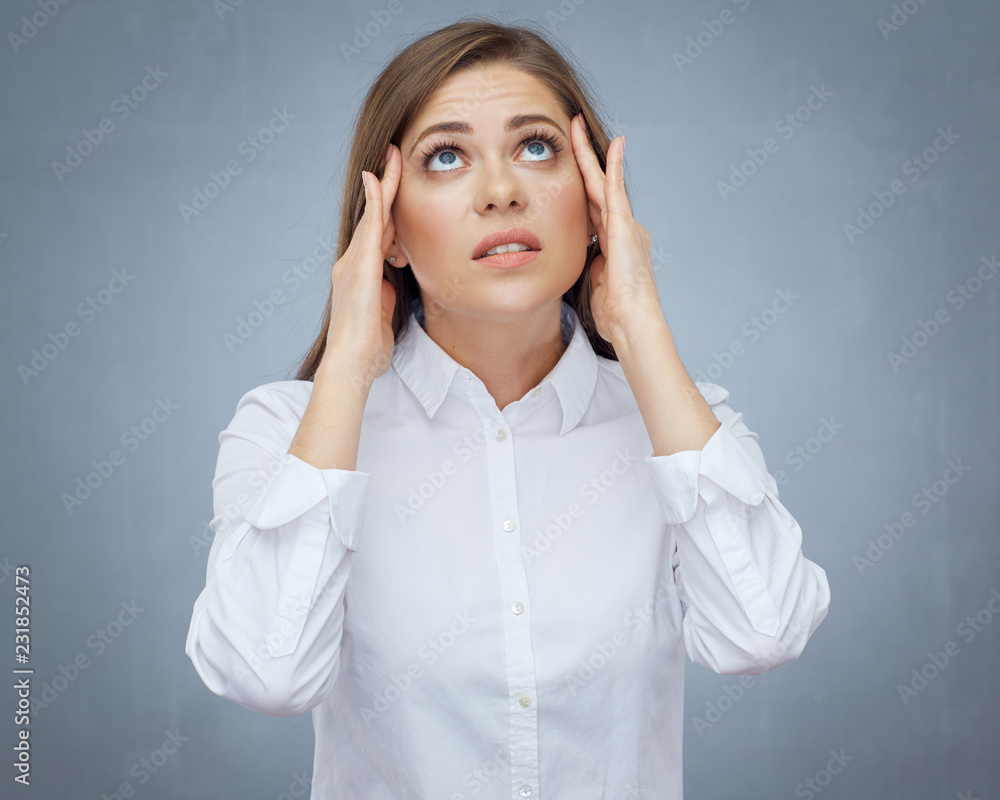 Woman with headache looking up and touching head. Woman with headache looking up and touching head.