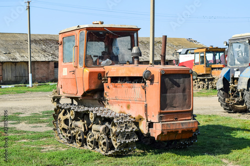 Russia, Temryuk - 15 July 2015: Tractor. Agricultural machinery tractor. Parking of tractor agricultural machinery. The picture was taken at a parking lot of tractors in a rural garage on the © eleonimages