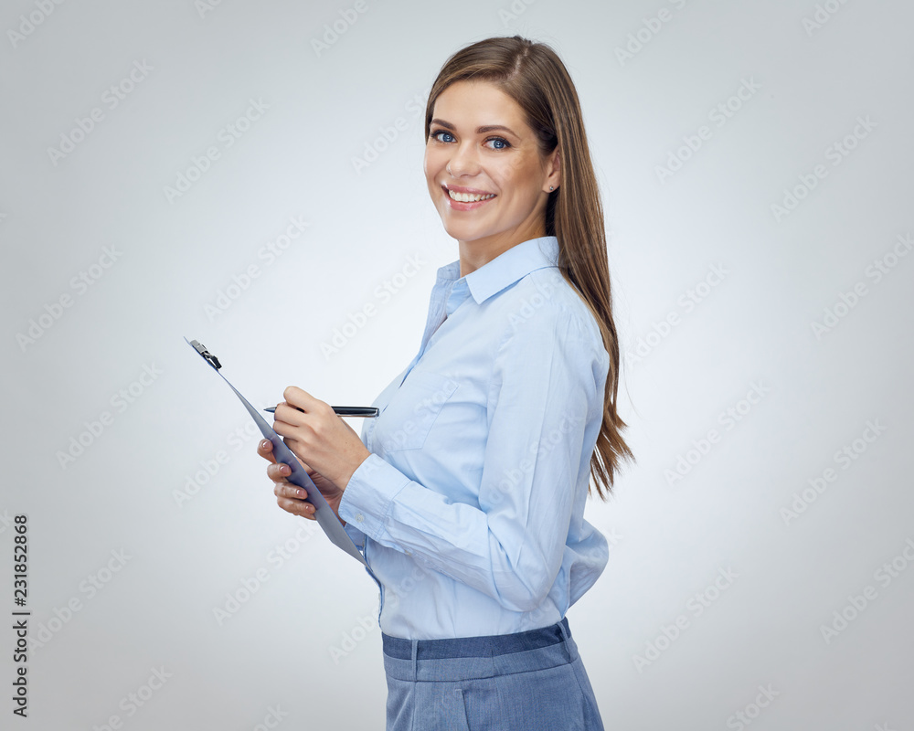 Smiling business woman writes in notebook. Smiling business woman writes in notebook.