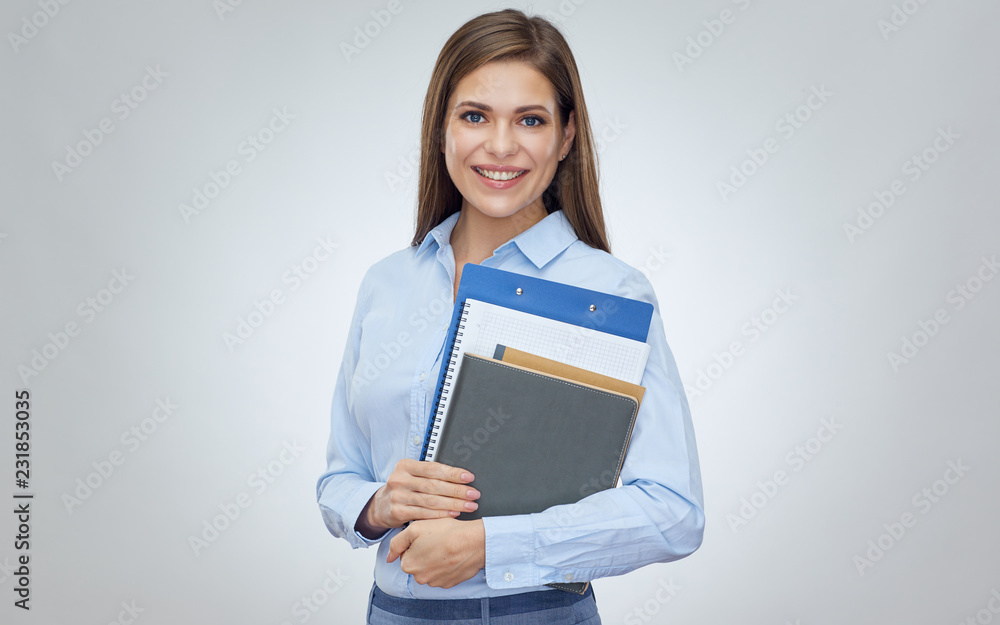 Smiling woman teacher or student holding book, notebook, workbook. Smiling woman teacher or student holding book, notebook, workbook.