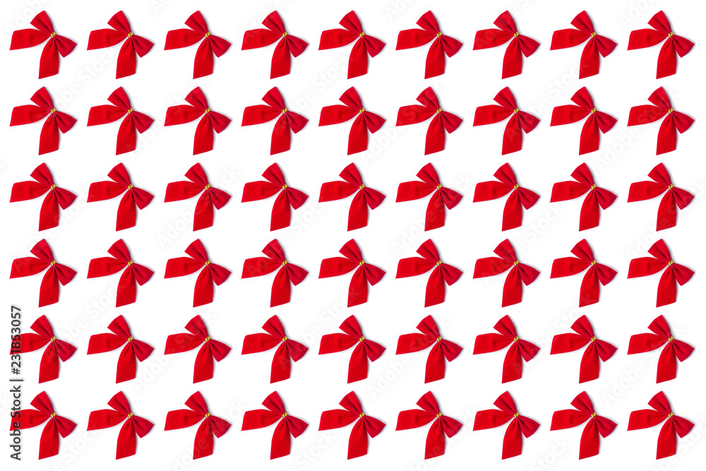 Red festive bows on a white background. Christmas original concept, preparation for gift paper and wallpaper.