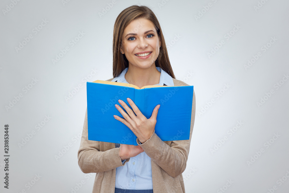 Smiling woman teacher reading open book. Smiling woman teacher reading open book.