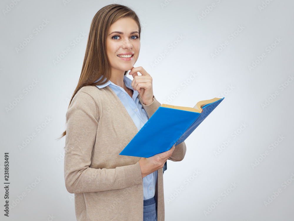 Thinking smiling woman teacher holding open book. Thinking smiling woman teacher holding open book.
