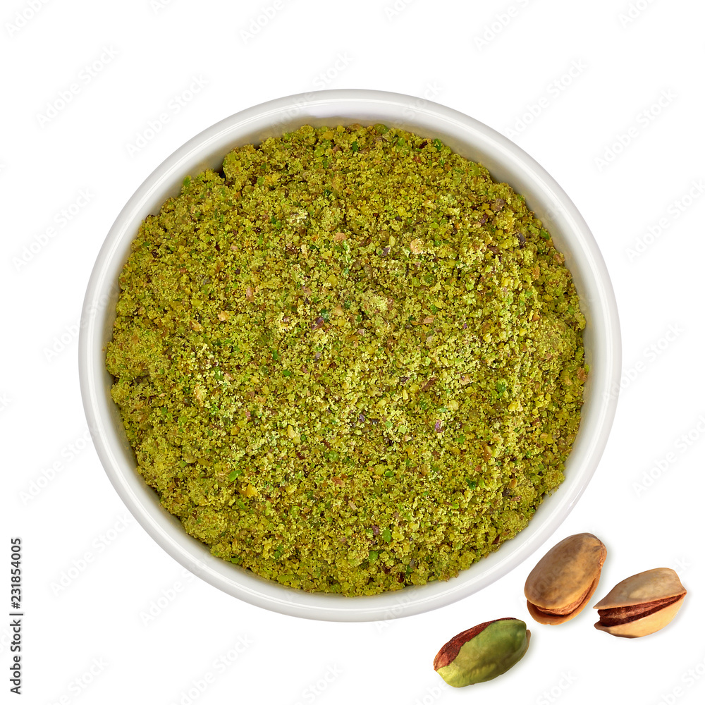 Ground, milled, granulated or crushed pistachios in bowl isolated on white background Ground, milled, granulated or crushed pistachios in bowl isolated on white background