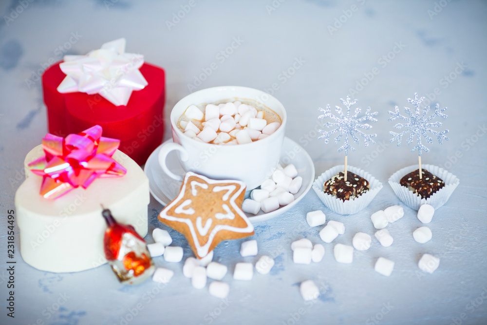 Hot coffee with marshmallows and gingerbread cookies on the light gray background. Beautiful Christmas decorations with gifts and sweets. Space for a text. Close up. Hot coffee with marshmallows and gingerbread cookies on the light gray background. Beautiful Christmas decorations with gifts and sweets. Space for a text. Close up.