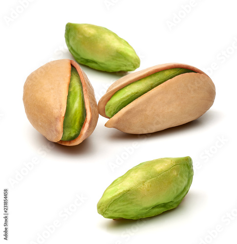 Peeled and unpeeled pistachios isolated on white background