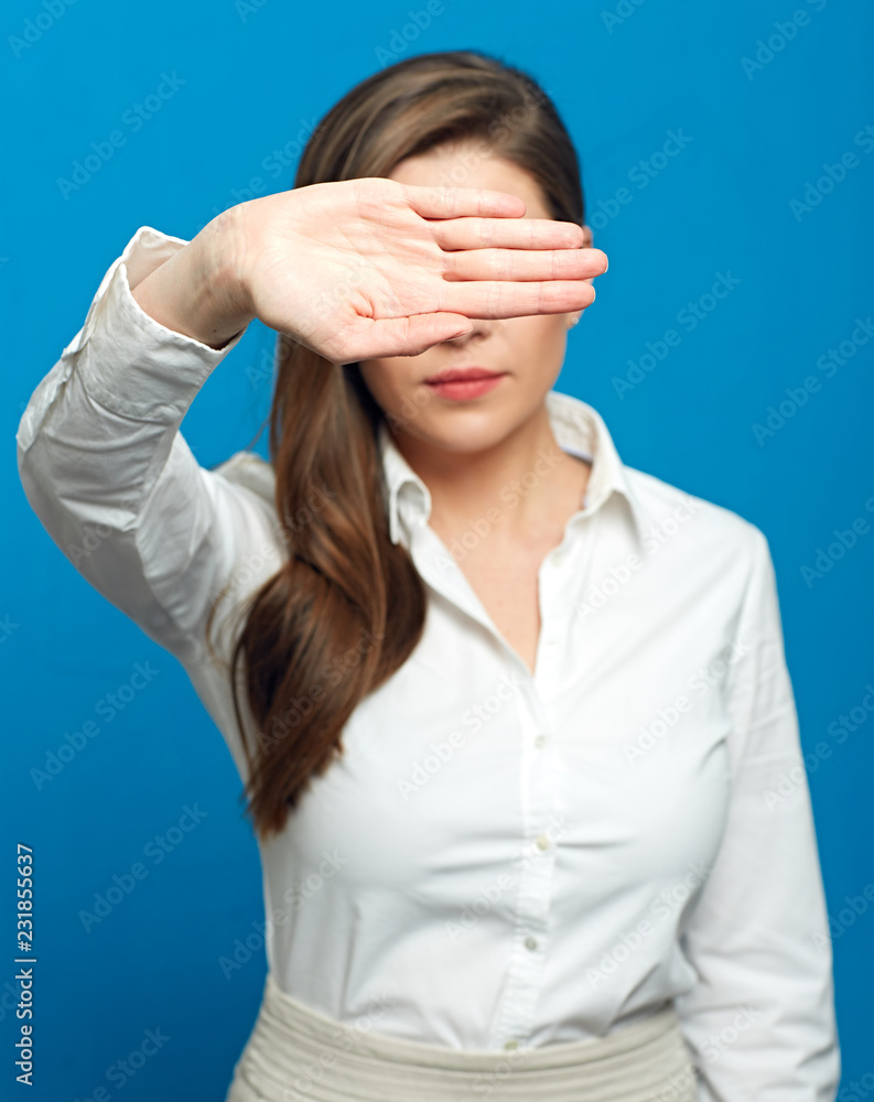 Woman showing stop symbol with outstratched hand and closed eyes Woman showing stop symbol with outstratched hand and closed eyes