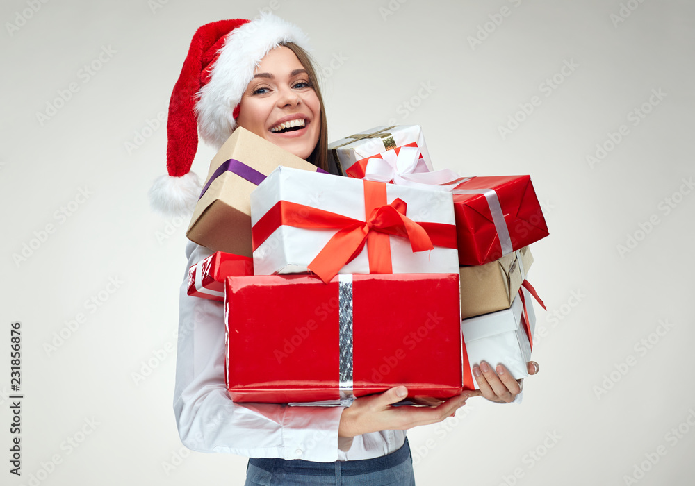 Happy woman wearing santa hat holding pile of gifts. Happy woman wearing santa hat holding pile of gifts.