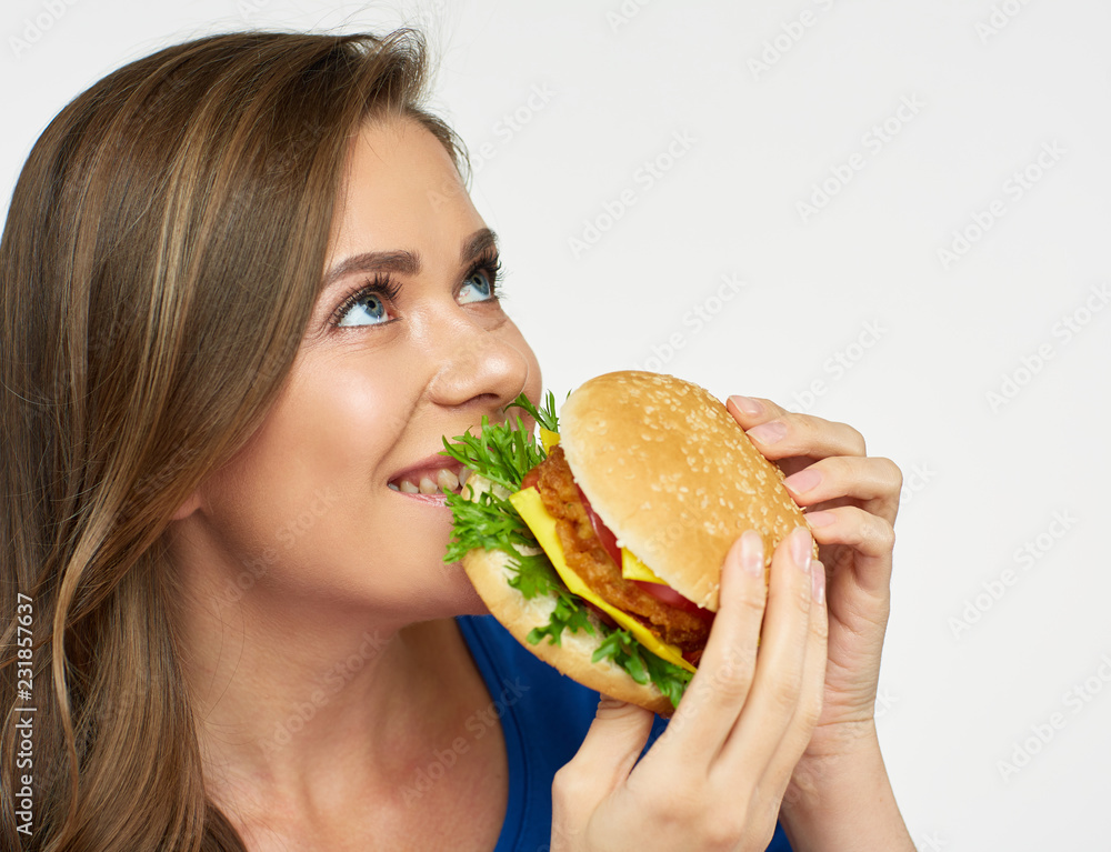 Smiling woman eat fast food burger.