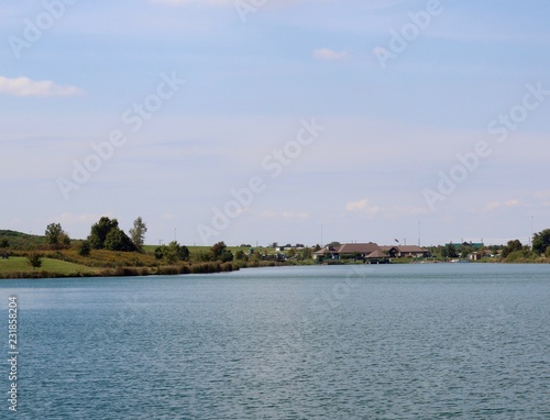 A view of the lake in a countryside park on a sunny day.