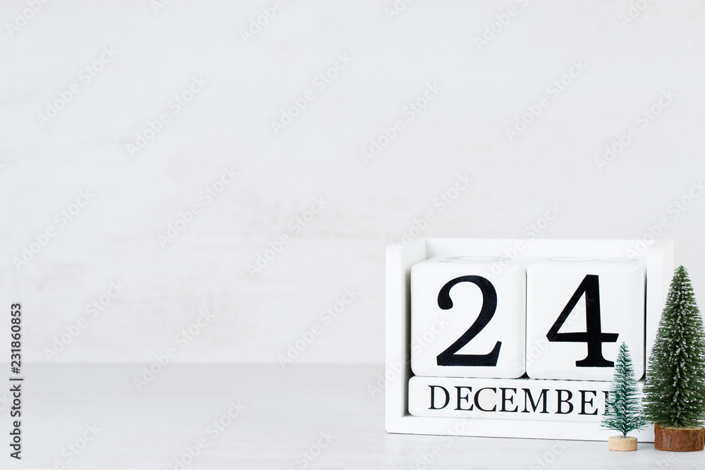 Wooden Calendar December 24 Christmas Day. On a gray background with christmas decor. Wooden Calendar December 24 Christmas Day. On a gray background with christmas decor.