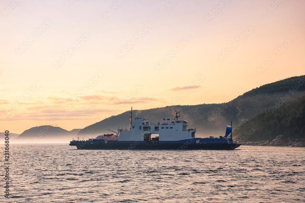 Ferry crossing Saguenay river at dusk, Quebec, Canada