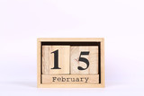 Wooden cubes calendar with the date of February 15. Concept calendar for year with copy space isolated on white background