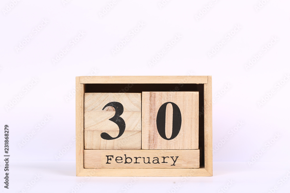Wooden cubes calendar with the date of February 30. Concept calendar for year with copy space isolated on white background Wooden cubes calendar with the date of February 30. Concept calendar for year with copy space isolated on white background