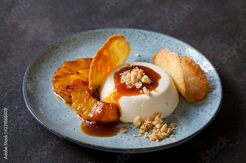 Slika na platnu Panna cotta with caramelised pineapple and coconut biscuit