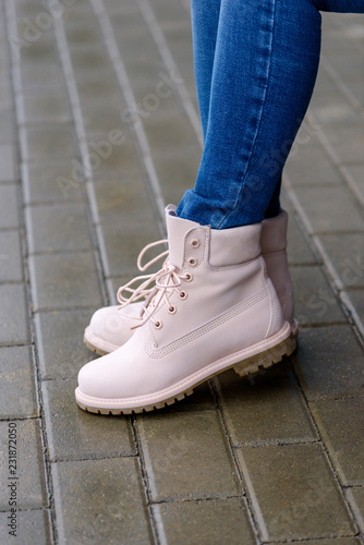 Pink leather boots on woman's legs