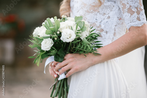 Bride with a beautiful wedding bouquet in light colors