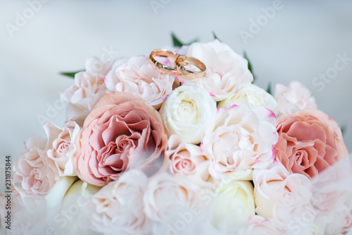 wedding golden rings with pastel pink rose
