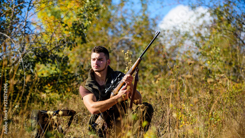 Hunting skills and strategy. Hunting strategy or method for locating targeting and killing targeted animal. Man hunting wait for animal. Hunter with rifle ready to hunting nature background