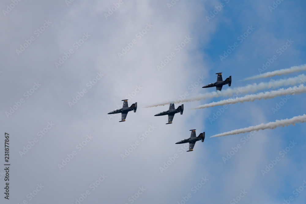 Low angle view of airshow in cloudy sky Low angle view of airshow in cloudy sky