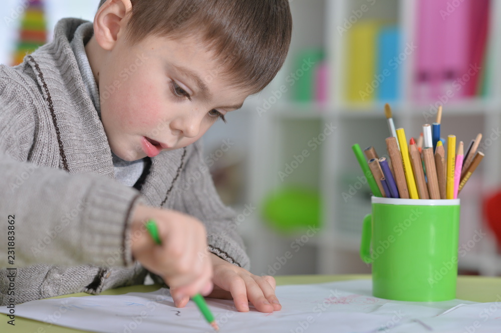 Portrait of a little boy drawing with pencil Portrait of a little boy drawing with pencil